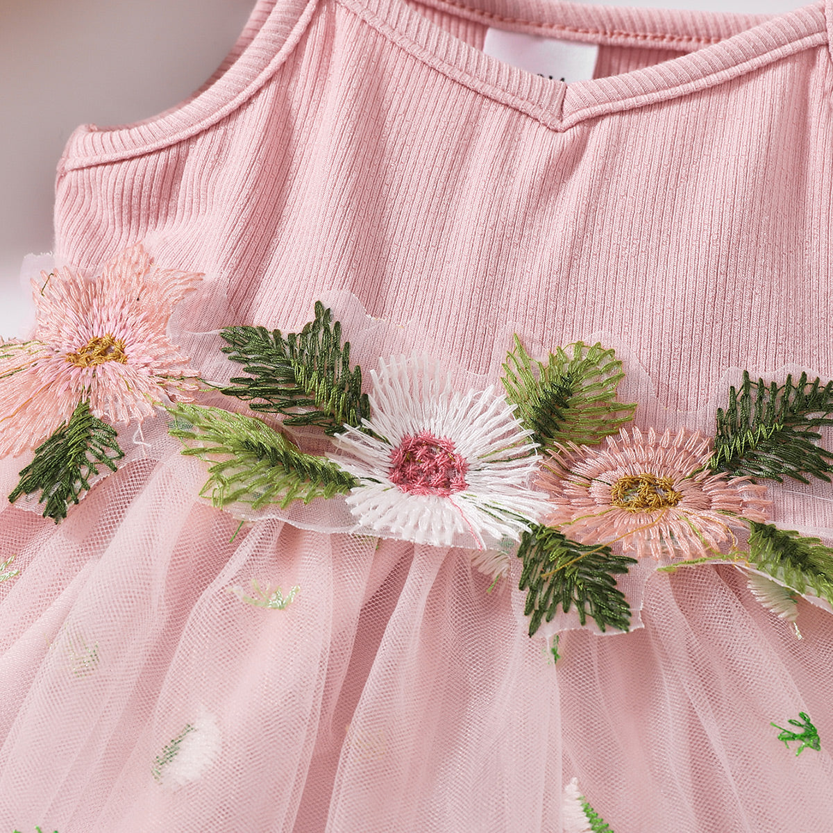 The perfect Sweet Spring Dress for a budding ballerina or fairy. Complete with flowers Embroidered at the waist and on the tulle skirt.. Perfect for Spring and Summer events!