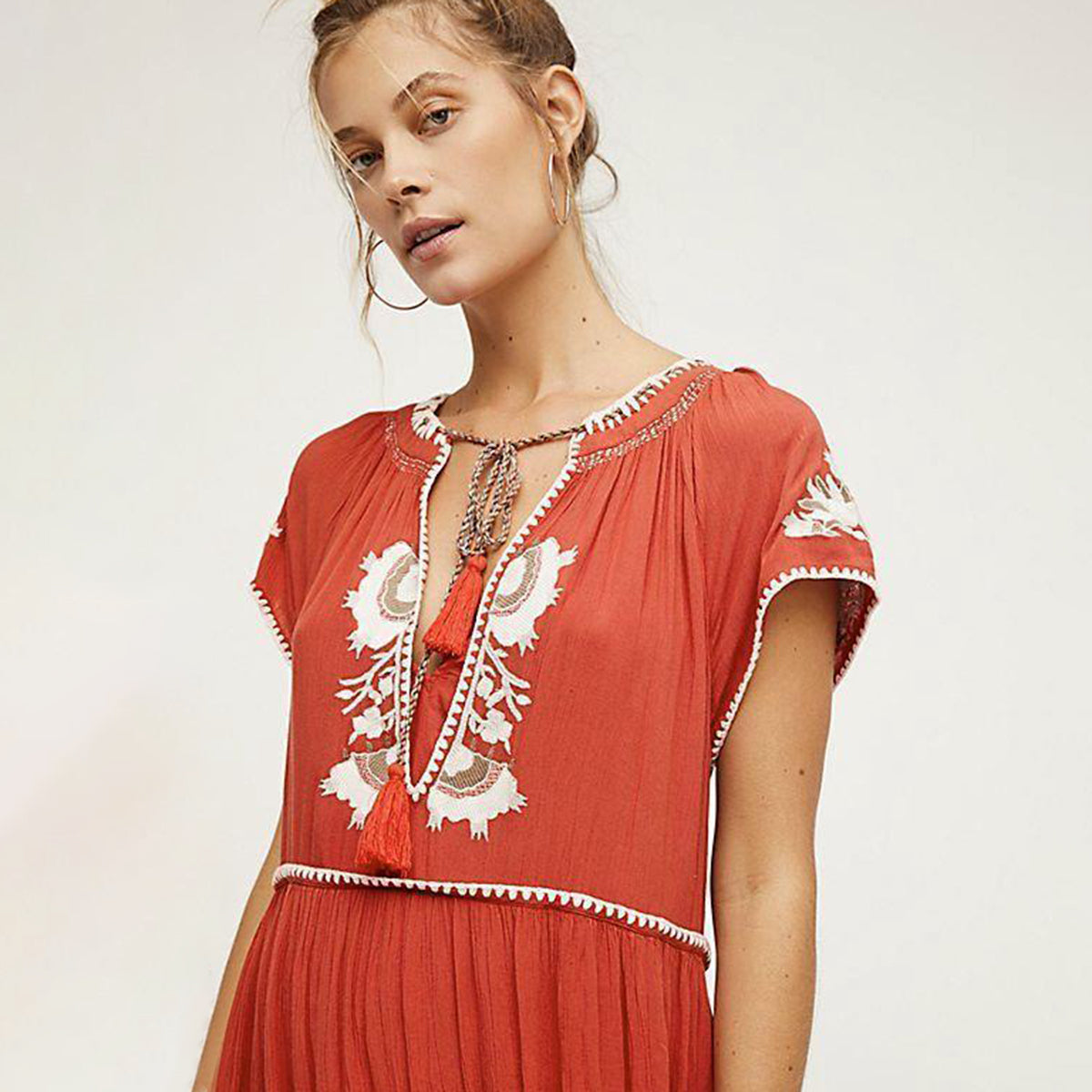 Great looking Maxi Dress with Lace Up Tassel neckline and Elegant Embroidery. Comes in Paprika, Indigo and Snow!